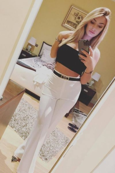 A selfie of Ada looking hot in white trousers