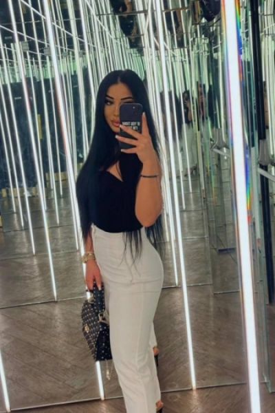 A selfie of escort lady named Octavia who is wearing white trousers