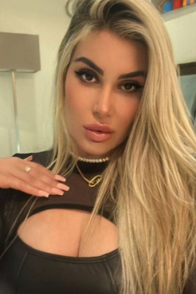 Selfie of a very sexy blonde Brazilian escort lady wearing a cut out top 